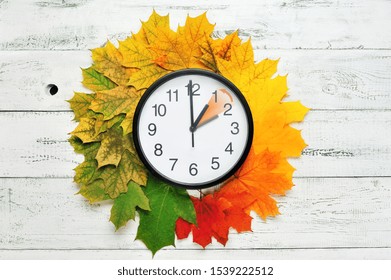 Fall Time Change Still Life With Maple Tree Foliage And Wall Clock