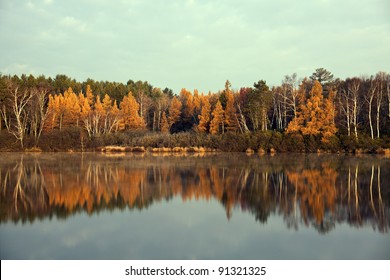 Fall In Tomahawk, Wisconsin. Colorful Trees Reflected In The Lake.