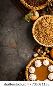 Fall Traditional Pies Pumpkin, Pecan And Apple Crumble Pie Overhead Shot With Copyspace