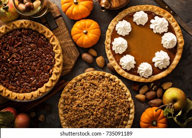 Fall traditional pies pumpkin, pecan and apple crumble pie overhead shot