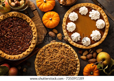 Fall traditional pies pumpkin, pecan and apple crumble pie overhead shot