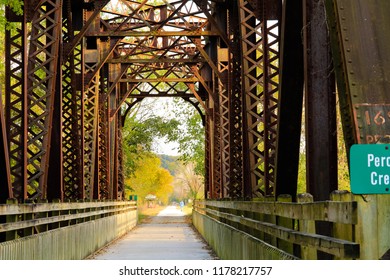 Fall View Of A Former Railroad Bridge Converted Into A Trail In Missouri State Park In The Fall; Fall Trees In The Background