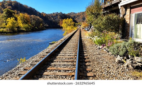 a fall view of train tracks that run alongside the French Broad river  in Marshall, NC