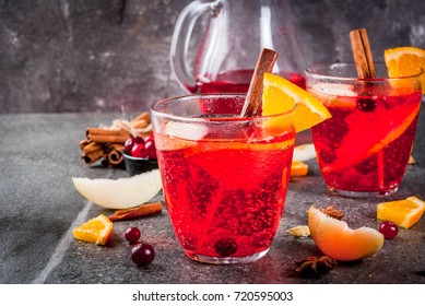 Fall And Winter Cold Drinks, Cranberry And Orange Holiday Christmas Punch With Cinnamon, Anise Stars,  On Black Background Copy Space