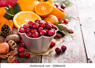 Fall And Winter Ingredients Still Life With Oranges, Cranberry, Nuts And Spices