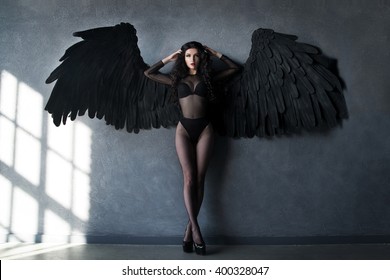 Fallen Black Angel With Wings. Sexual Woman