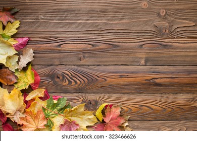 fallen leaves on wooden background, top view, copy space - Powered by Shutterstock