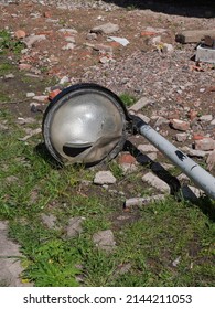 Fallen Street Lamp With Broken Shade Between The Stone Rubble