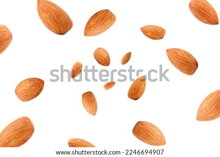 Falling almond isolated on white background, selective focus