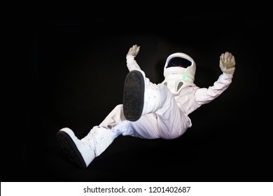 falling Astronaut in space, in zero gravity on black background.
