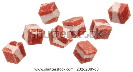 Falling bacon cubes, diced smoked ham isolated on white background