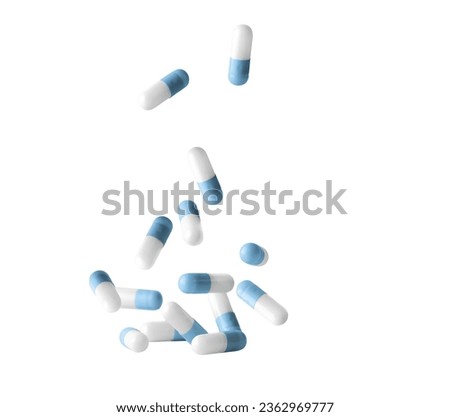 Falling blue medicine pill capsules isolated on white background. Antibiotics