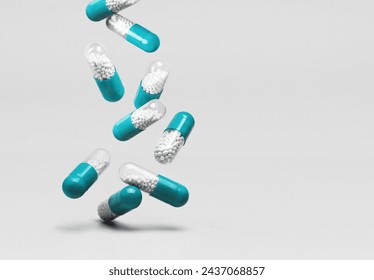 Falling blue white medicine pills capsules on white background. Copy space - Powered by Shutterstock