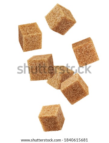 Falling Brown cane sugar cubes isolated on white background, clipping path, full depth of field