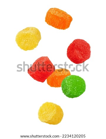 Falling candied fruit, multicolored pineapple, isolated on white background, full depth of field, clipping path