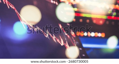 Falling candlestick trading chart on digital screen, enhanced with soft bokeh light effects, symbolizing financial loss and volatility.