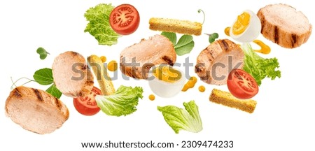 Falling chicken Caesar salad ingredients isolated on white background