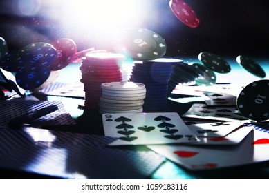 Falling Chips On The Playing Card Table In The Casino