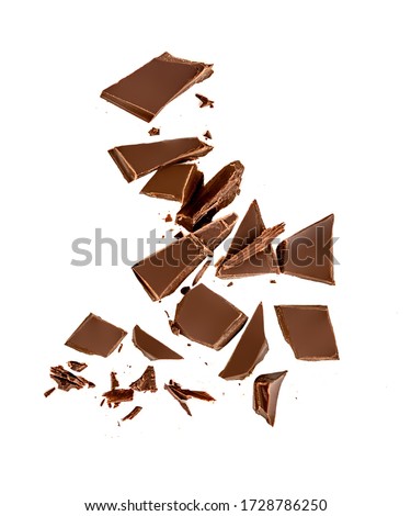Falling Chocolate pieces and  shavings  isolated on white background
