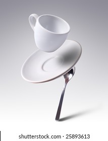 Falling Coffee Cup With Spoon And Saucer