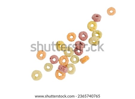 Falling colorful corn rings isolated on white background with clipping path.