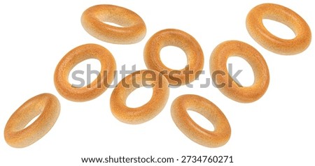 Falling crispy round bagel drying snacks isolated on white background, full depth of field