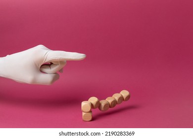 Falling dice concept. Structural destruction. A wooden cube tower pushed by a white-gloved hand. Market crash, crisis, lack of stability, failure and loss of balance. Copy space