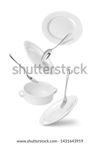 falling Dinnerware, plates, fork and spoons isolated