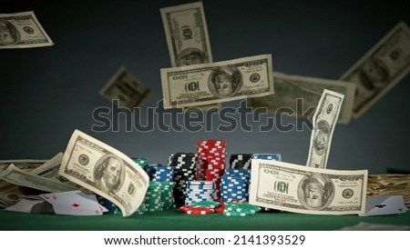 Falling dollars banknotes on the table, macro shot. Casino and gambling concept.