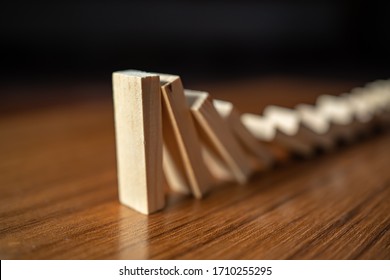 Falling dominoes on wooden table