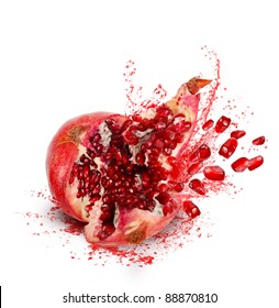 Falling Down Ripe Pomegranate With Cracks And Splashes Of Juice And Seeds On White Background