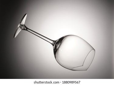 Falling Empty Broken Wine Glass On A Gray Background                             