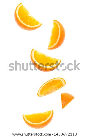 falling fresh orange fruit slices isolated on white background closeup. Flying food concept. Top view. Flat lay. Orange slice in air, without shadow.