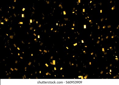 falling gold glitter foil confetti,  on black background, holiday and festive fun concept