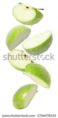 Falling green apple slice isolated on white background.