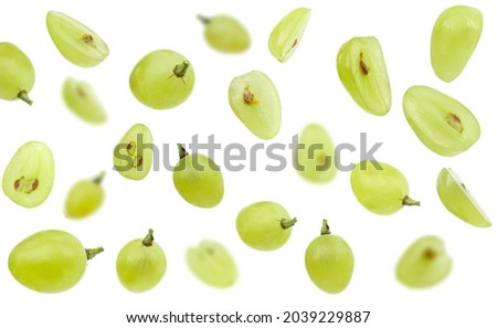 Falling green grape, isolated on white background, selective focus