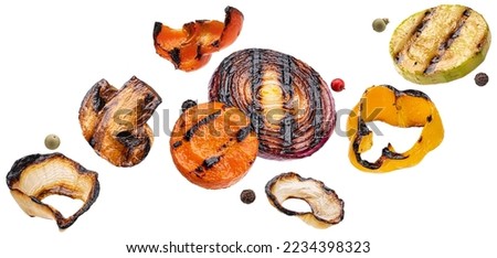 Falling grilled vegetable slices isolated on white background