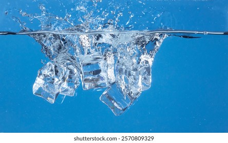 Falling ice cubes in motion with splashing water, creating air bubbles scatter around, blue background isolated. Ice cubes fall into water with air bubbles