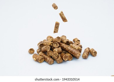 Falling Individual Pellets On A Slide Of Pellets On A Light Background. Wood Sawdust Pressed Into Pellets And Prepared According To A Certain Technology. Environmentally Friendly Fuel.