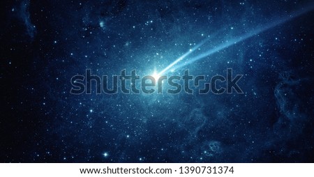 Falling meteorite, asteroid, comet in the starry sky. Elements of this image furnished by NASA. 