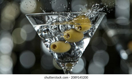 Falling olives into martini drink, freeze motion - Powered by Shutterstock