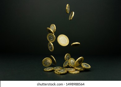 Falling one and two British pound coins on a black background  - Shutterstock ID 1498988564