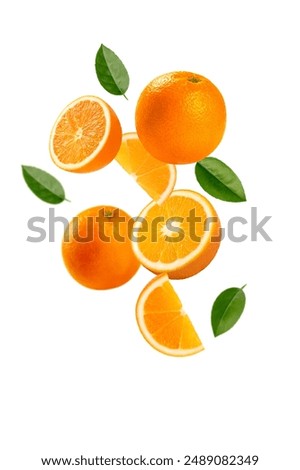 Falling orange fruits with cut in half and leaves isolated on white background.