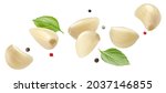 Falling peeled garlic cloves isolated on white background with clipping path