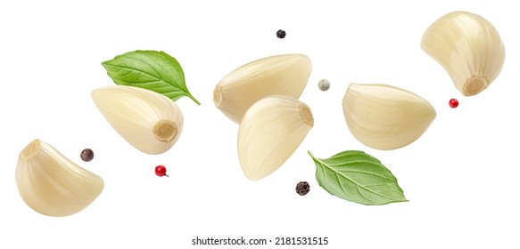 Falling peeled garlic cloves isolated on white background