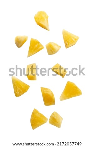 Falling pineapple slices isolated on white background with clipping path.