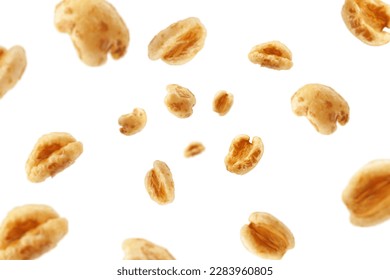 Falling puffed Wheat cereal, isolated on white background, selective focus