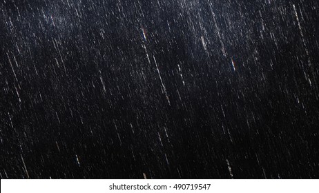 Falling raindrops footage animation in slow motion on dark black background with fog, lightened from top, rain animation with start and end, perfect for film, digital composition, projection mapping