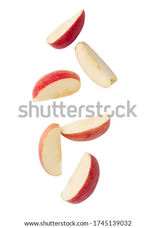 Falling red apple slice isolated on white background with clipping path.