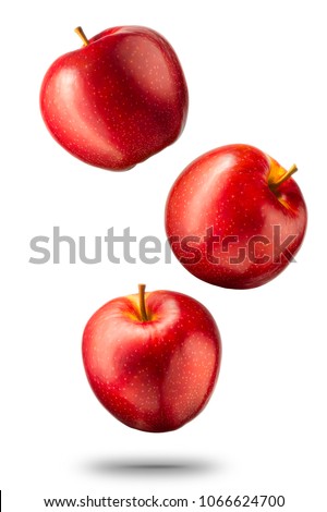 Falling red apples isolated on white background with clipping path and shiny reflections